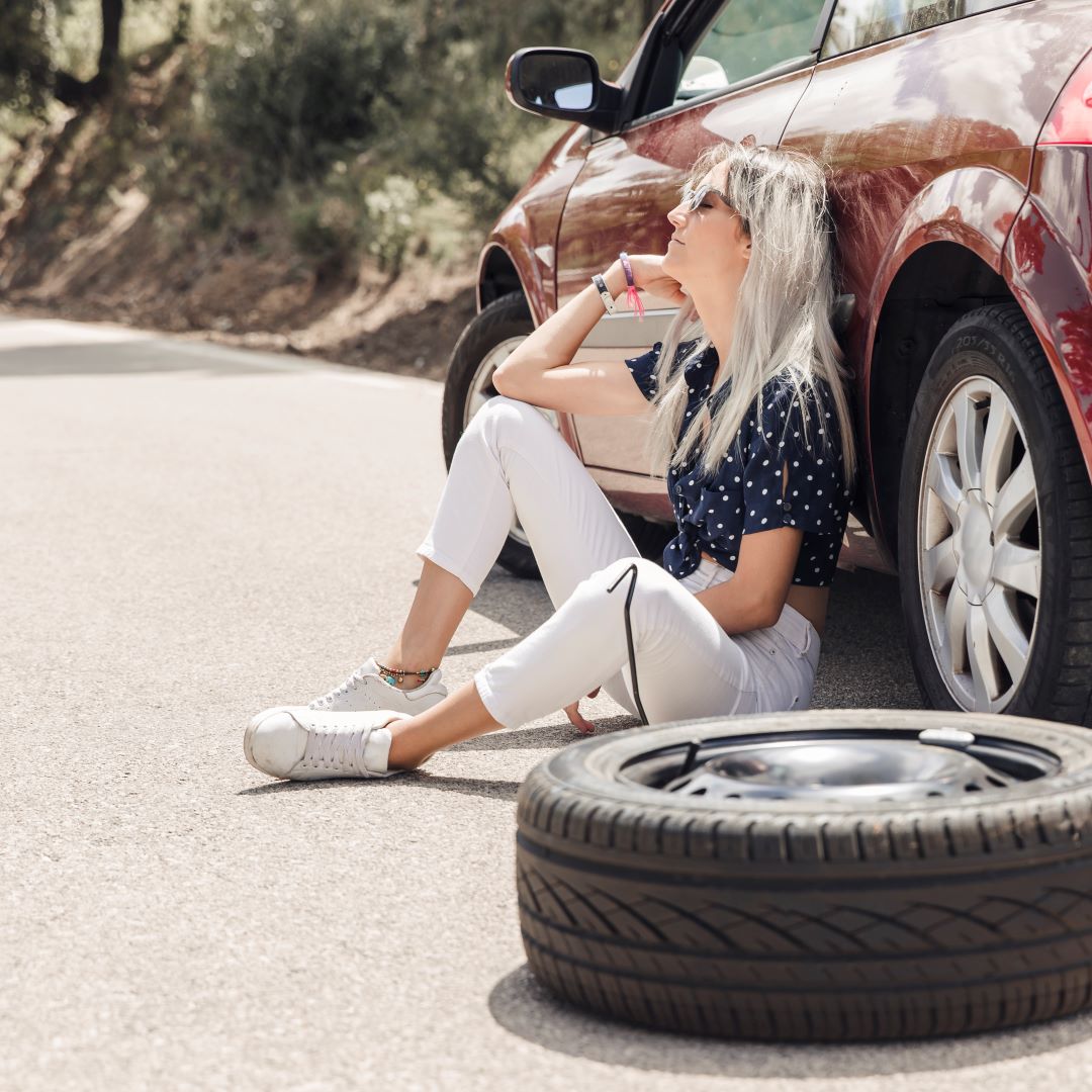 triste-mujer-joven-sentada-cerca-coche-averiado-carretera